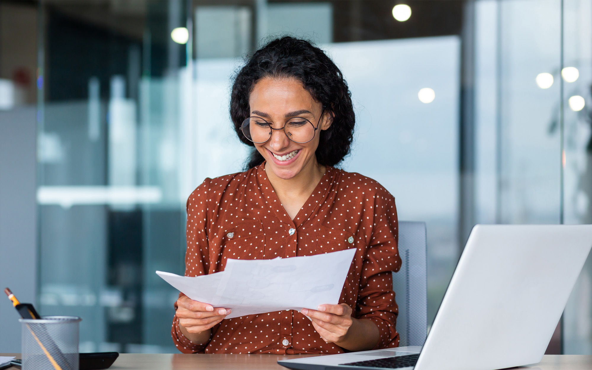 successful businesswoman in glasses working with documents inside office